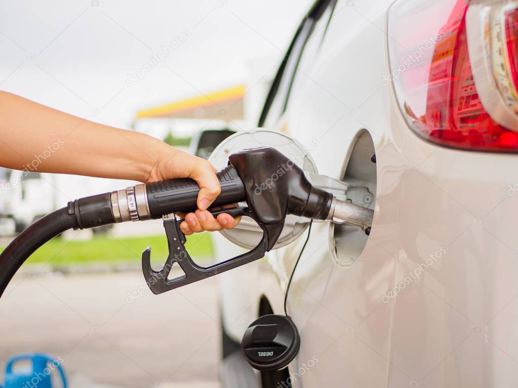 Filling gas at the station. Fill the gas tank. Self service. Gas pump in the car. Refill oil, gasoline, diesel vehicle