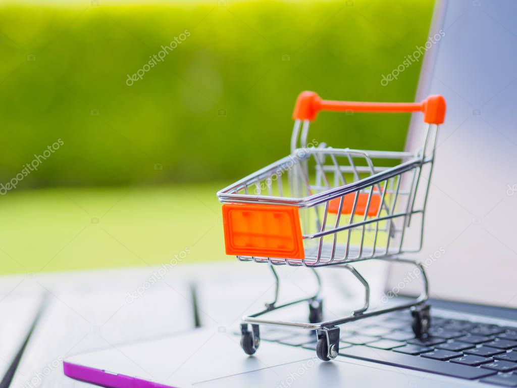 Shopping Online Concept : Mini Shopping Cart On Laptop