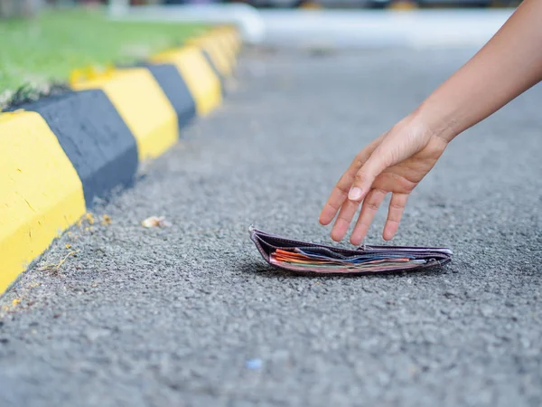 Yakın çekim, A kadın toplama kadar düşmüş cüzdan üzerinde yol yan — Stok fotoğraf