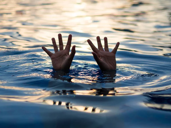 Drowning victims, Hand of drowning man needing help. Failure and rescue concept.