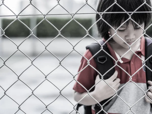 Portrait of handsome sad boy behind fence mesh netting. Emotions concept - sadness, sorrow, melancholy. Fashion & beauty concept. — Stock Photo, Image