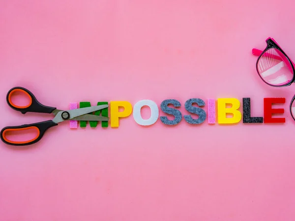 Cut the word impossible to possible. Alphabet I, M being cut. Change concept. — Stock Photo, Image