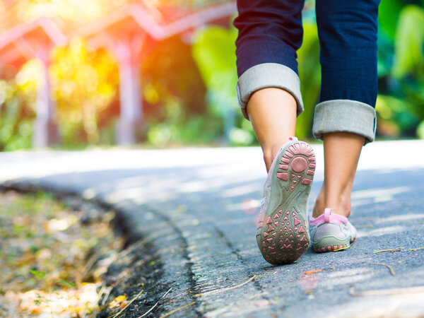 woman walking towards on the road side.