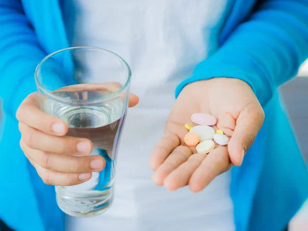 Medicine, health care and people concept - close up of woman taking in pill — Stock Photo, Image