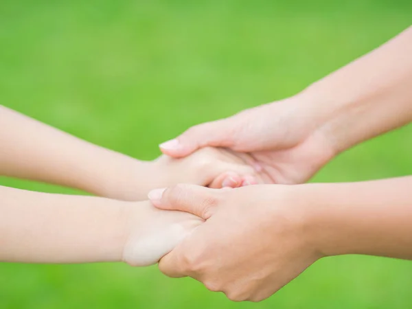 Woman holds the hand of lovely child. — Stock Photo, Image