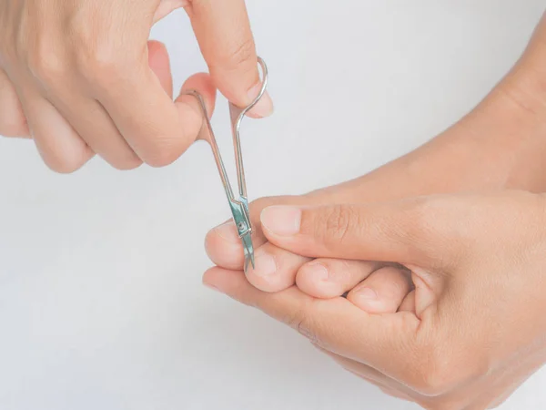 Closeup attractive young woman cutting her feet nails. Health ca — Stock Image Closeup attractive young woman cutting her feet nails. Health ca Royalty Free Stock Photos