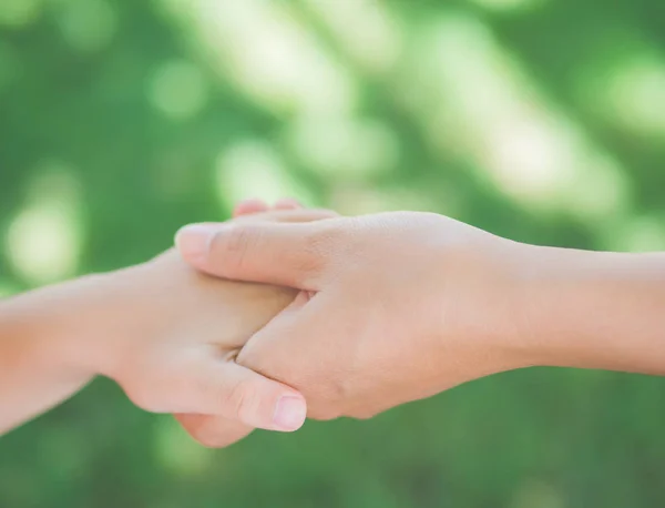 Close up of woman  holds the hand of a lovely child. — Stock Photo, Image