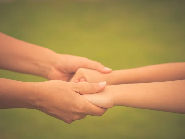 Soft focus woman  holds the hand of a lovely child. — Stock Photo, Image