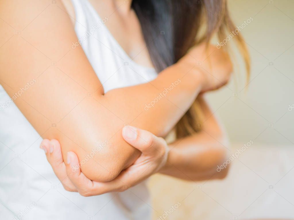Closeup female's elbow. Arm pain and injury.