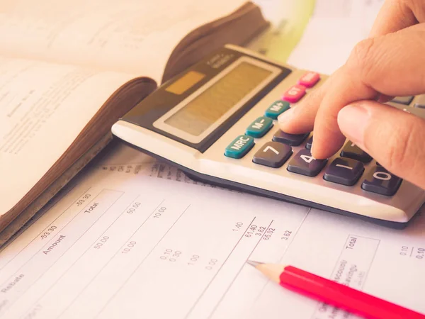 Fechado mão mulher usando calculadora com acessórios de escritório no fundo branco . — Fotografia de Stock