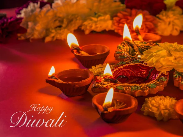 Colorful traditional clay diya lamps and flowers — Stock Photo, Image