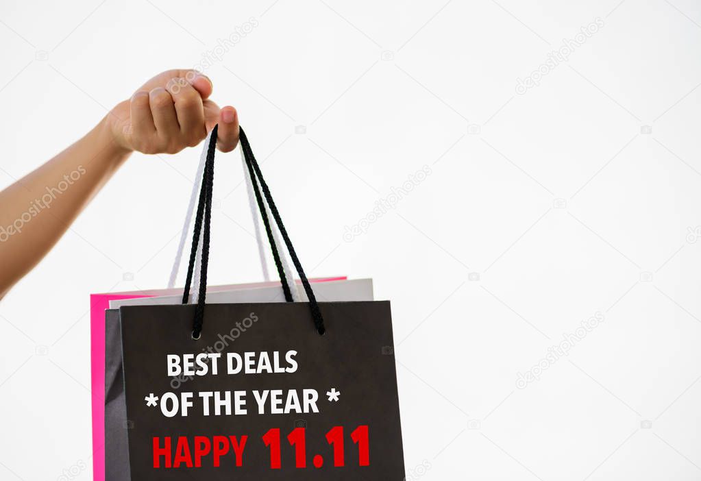 Hand holding shopping bags for China 11.11 single day sale concept