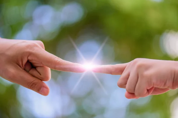 Close up of mother and kid hands pointing with finger over green bokeh background.. — Stock Photo, Image