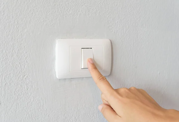 Close up of woman finger  turning on light switch Royalty Free Stock Images