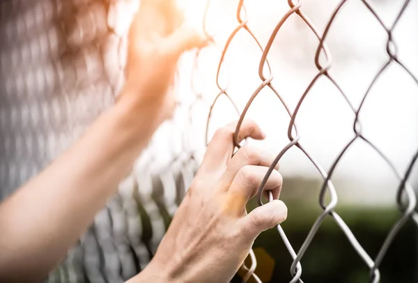 Mulher mão segurando em cerca elo cadeia para lembrar conceito Dia dos Direitos Humanos . — Fotografia de Stock
