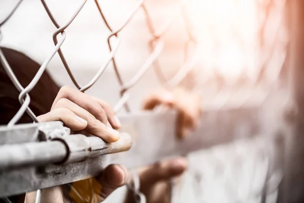 Woman hand holding on chain link fence for remember Human Rights Day concept. — Stock Photo, Image