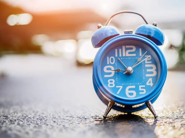 Closeup alarm clock  with sunset  background. — Stock Photo, Image