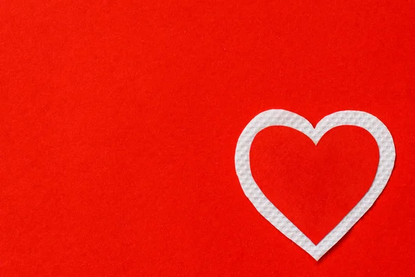 Big red and white heart paper on red paper background.