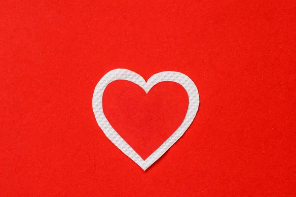 Big red and white heart paper on red paper background.