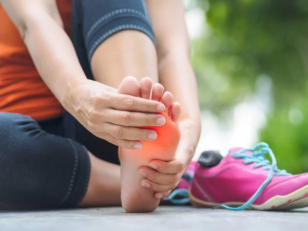 Vrouw lijdt een enkel letsel tijdens het sporten. — Stockfoto