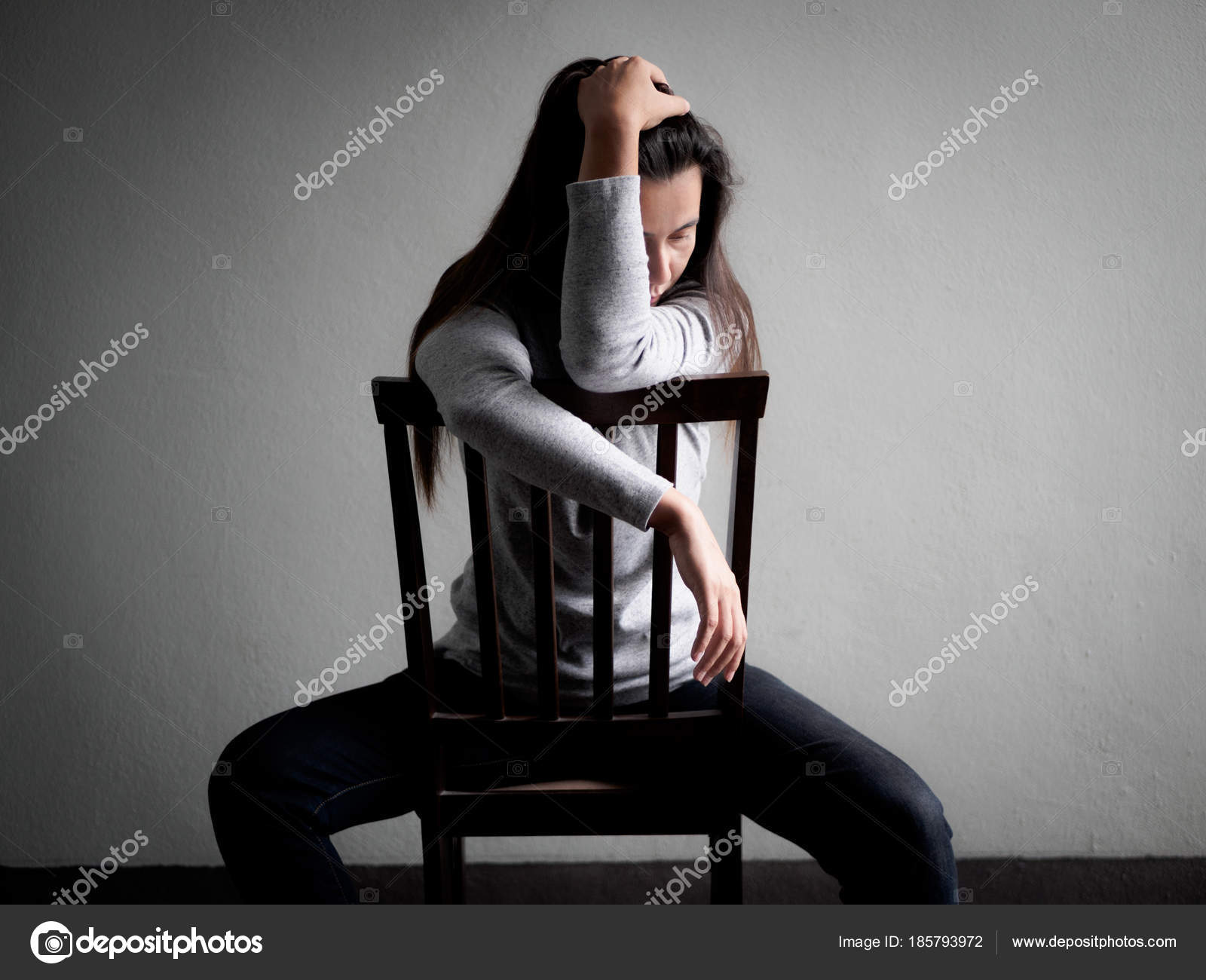 Depressed Broken Hearted Woman Sitting Alone On A Wooden Chair