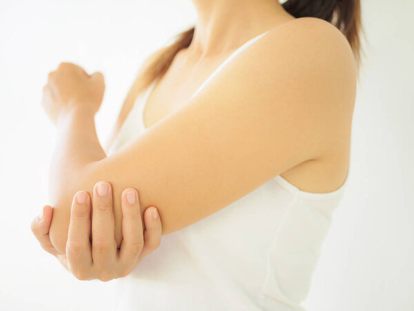 Close up woman having pain in injured elbow. 