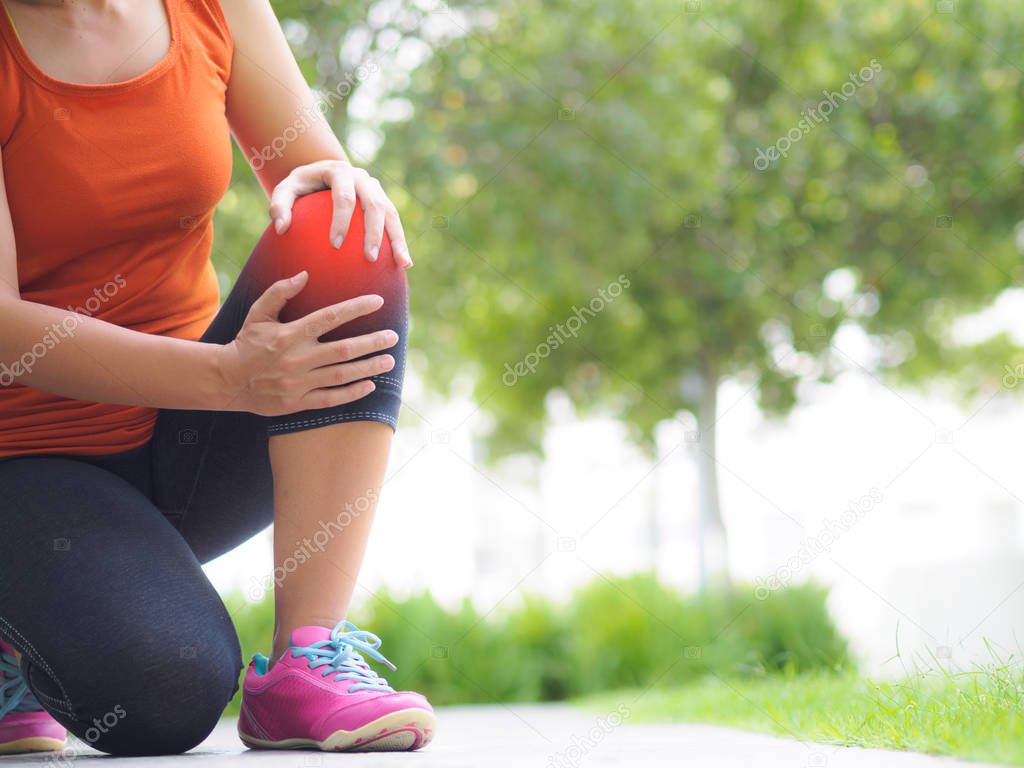 Runner sport knee injury. Woman in pain while running 