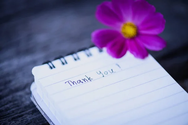 Thank You text on a white page note book with romantic white flower — Stock Photo, Image