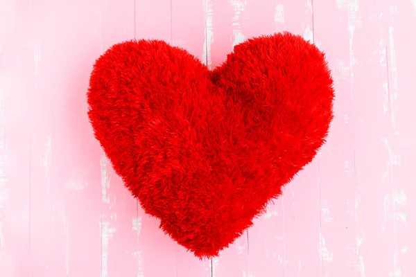 Beautiful big red pillow heart shape on white and pink wooden background. — Stock Photo, Image