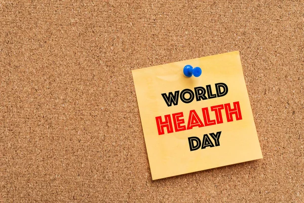 World health day message on yellow note pad.