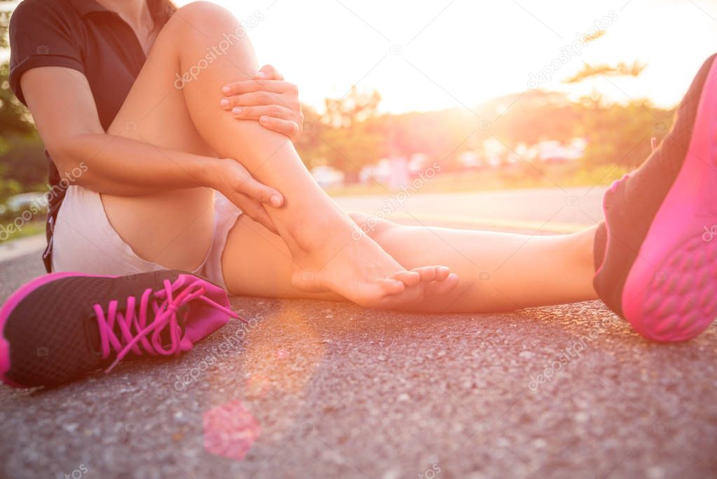 Ankle sprained. Young woman suffering from an ankle injury