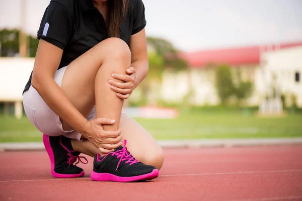 Ankle sprained. Young woman suffering from an ankle injury