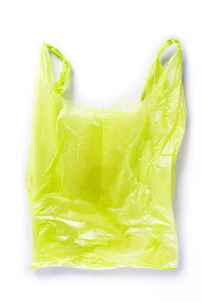 Vista superior de la bolsa de plástico verde sobre fondo blanco. Reducción de bolsas de plástico para tratamiento natural. Concepto de reciclaje y Día Mundial del Medio Ambiente . — Foto de Stock