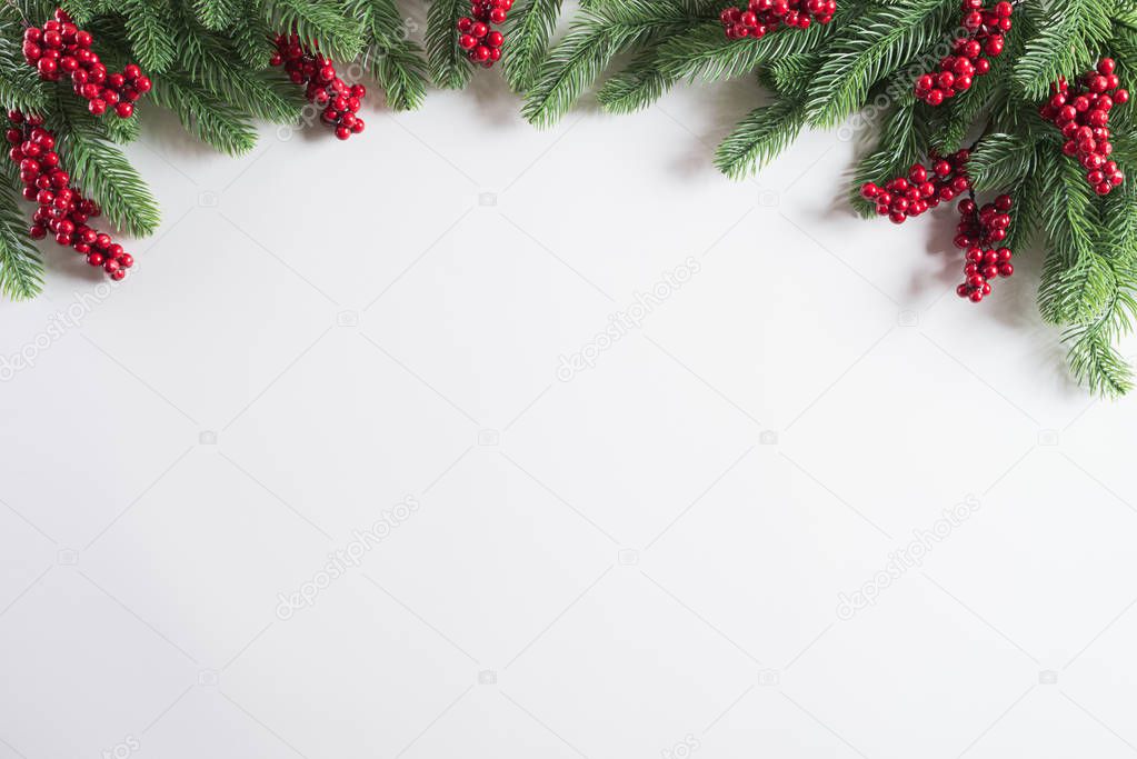 Christmas background concept. Top view of Christmas gift box red balls with spruce branches, pine cones, red berries and bell on white background.