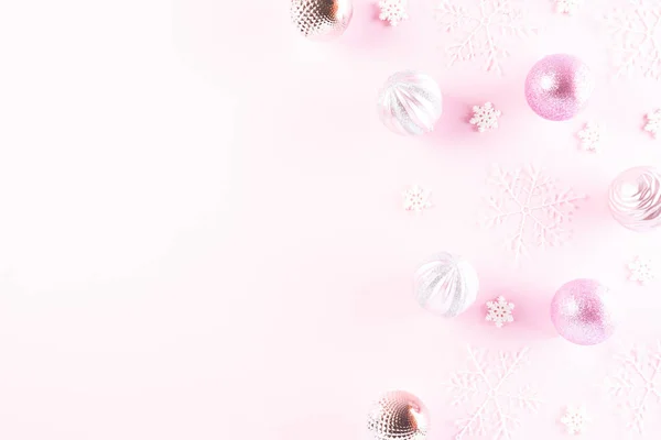 Χριστουγεννιάτικο φόντο. Κάτοψη της Χριστουγεννιάτικης μπάλας με νιφάδες χιονιού σε ανοιχτό ροζ παστέλ φόντο. — Φωτογραφία Αρχείου