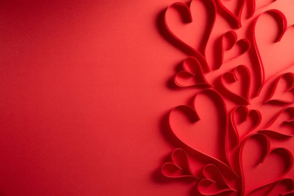 Cuori di carta rossa su sfondo di carta rossa. Amore e concetto di San Valentino . — Foto Stock