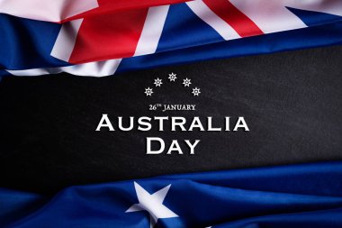 Avustralya günü konsepti. Avustralya bayrağı üzerinde Mutlu Avustralya günü yazılı karatahta arka planına karşı. 26 Ocak.