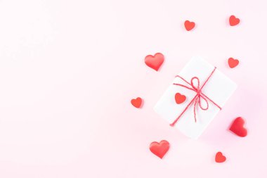 Pink paper hearts with gift box on Light pink pastel paper backg