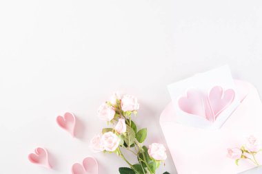 Pink paper hearts with gift box and roses on Light pink pastel p