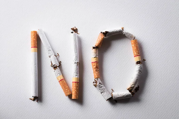 World No Tobacco Day concept, May 31. No smoking sign made with broken cigarettes on white background.