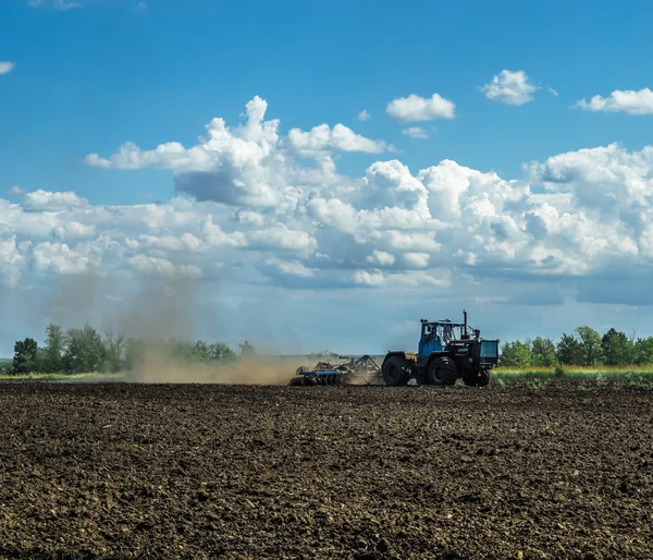 Tarım peyzaj - sahada çalışan traktör - bahar güneşli gün — Stok fotoğraf