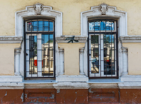 The windows of the old house where the tram is reflected