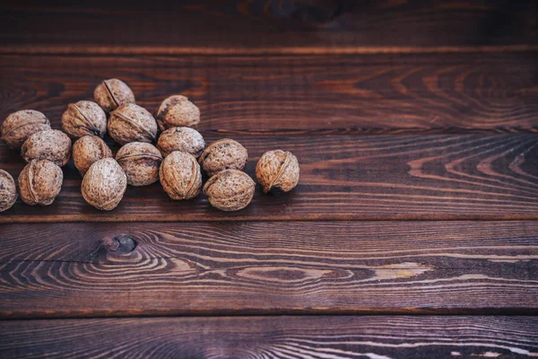 Natural walnuts on a wooden background. copyspace — Stock Photo, Image