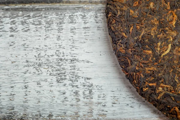 Close up imagem velho Shu puerh chinês fermentado chá no rústico fundo de madeira — Fotografia de Stock
