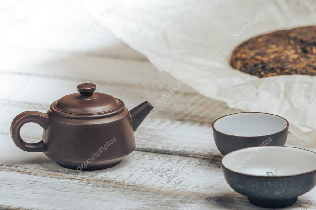 Teapot from Yixing clay for Chinese tea ceremony on rustic wooden background 