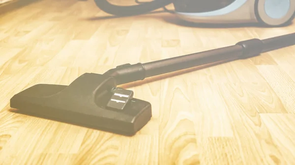 Close up of hoover or vacuum cleaner on floor at home, housework and cleaning — Stock Photo, Image