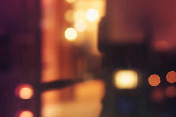 Abstract defocused bokeh blurred background of warm night lights in yellow and orange tones