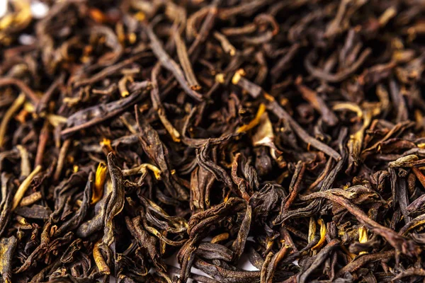 Sarı çizgileri, klasik Çin çay Dian Hong, arka plan siyah çay — Stok fotoğraf