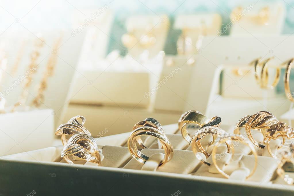 Jewelry in the shop window, Gold rings with diamonds, copy space