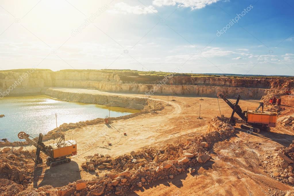 Open cast quarry, machines, excavators in quarry limestone mining